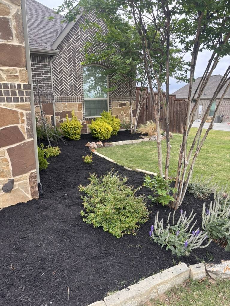 Residential landscape with refreshed beds and sharp mulch lines